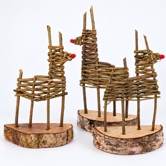 Three rustic twig llama sculptures on round wood bases, featuring woven brown branches with small red nose accents, set against a plain white background.
