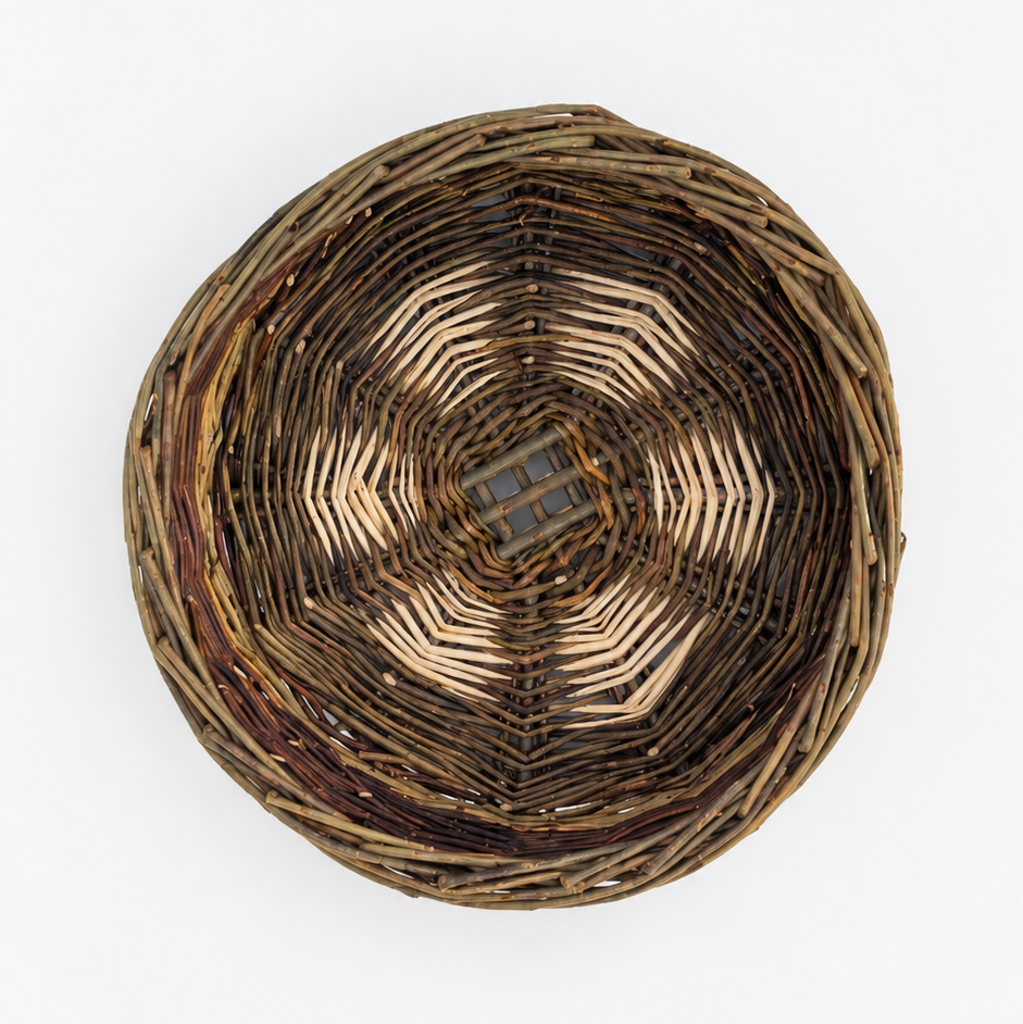 A round woven basket viewed from directly above on a plain white background.